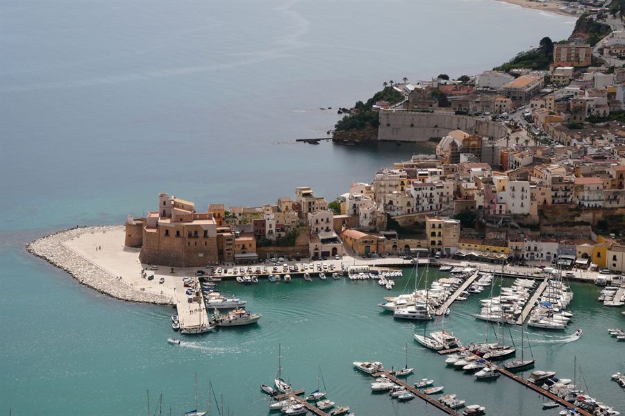 Aerial view of a Sicilian harbor town with boats in the marina